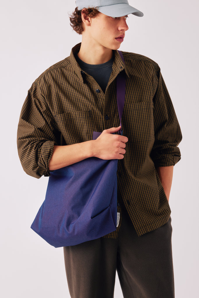 FW26 on-model fit reference. Shown: Flat Hem Work Shirt - Navy Club Check; Guide Hat - Light Blue; Zip Tote - Purple. Photograph 24246.